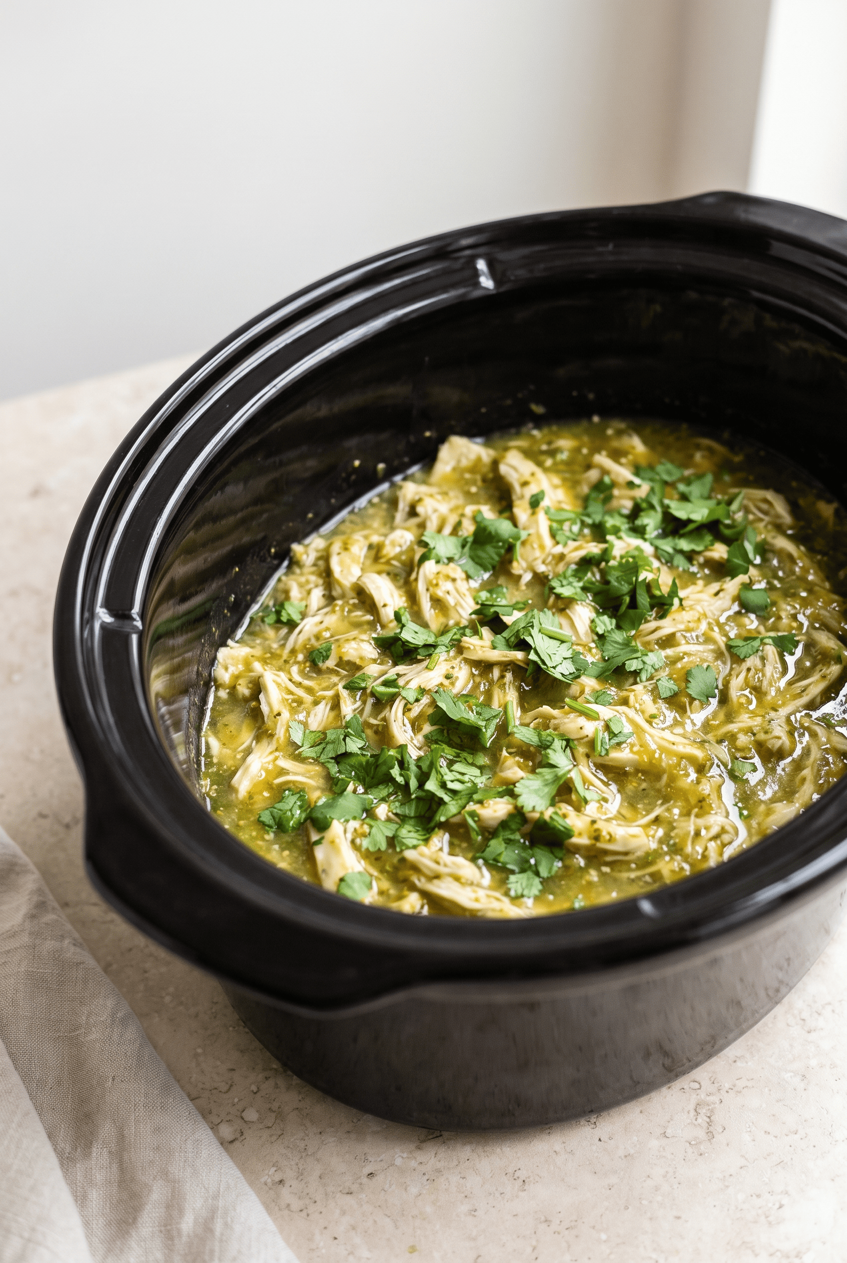 Crockpot salsa verde chicken finished in the slow cooker