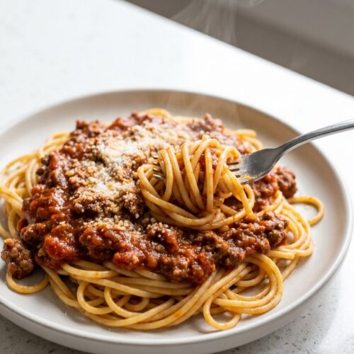 Spaghetti twirled with a rich ground beef meat sauce and grated parmesan